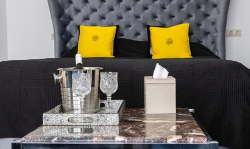 - un canapé noir avec des oreillers jaunes et une table dans l'établissement Central Park studio, à Gulbene