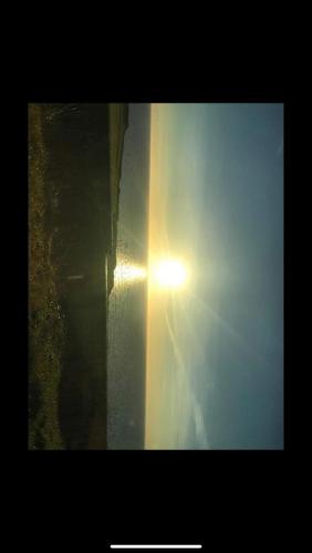a beam of sunlight shining through a window at Four waves in Thurso