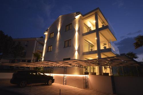 a car parked in front of a building at night at Villa Lungomare in Malinska