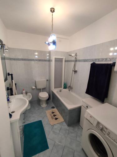 a bathroom with a sink and a washing machine at Residence Eurotel da Nella e Stefano in Rapallo