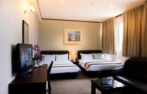 Postel nebo postele na pokoji v ubytování Hotel Vistaria