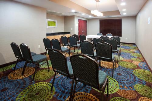 a room with a bunch of chairs in a room at Holiday Inn Express and Suites Rochester West-Medical Center by IHG in Rochester