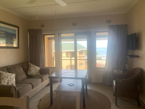 a living room with a couch and a table at Holiday unit 37 Eden dunes in Shelly Beach