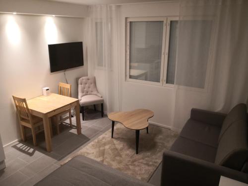 Una pequeña sala de estar con una mesa y un sofá. en Levi Ski-Star 314, en Levi