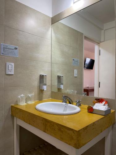 a bathroom with a sink and a large mirror at Posada de los Poetas Hotel Boutique in San Lorenzo