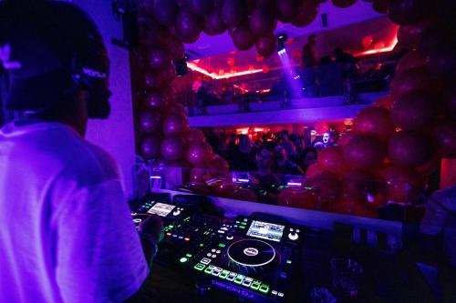 a dj in a nightclub with a crowd of people at Hôtel Rembrandt in Tangier
