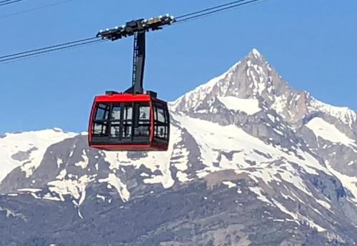 a ski lift in front of a snow covered mountain at Atelier 1786 in Staldenried