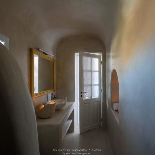 a bathroom with a sink and a mirror at Aghios Artemios Traditional Houses in Imerovigli