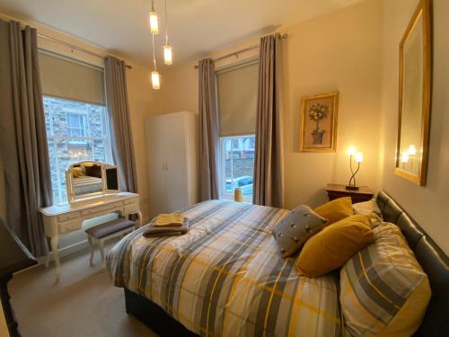 a bedroom with a bed and a window at Fabulous 2 bed Ground floor apartment Belper in Belper