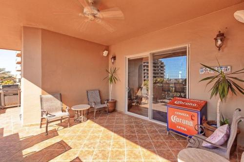 a living room with a large window and a patio at Bella Sirena 305-A - Elegant Oceanview Condo on Beachfront Resort in Puerto Peñasco