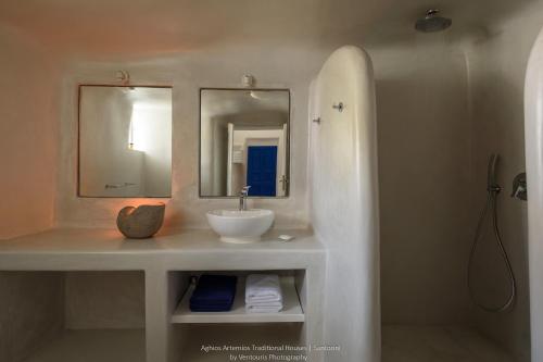 a bathroom with a sink and a mirror at Aghios Artemios Traditional Houses in Imerovigli