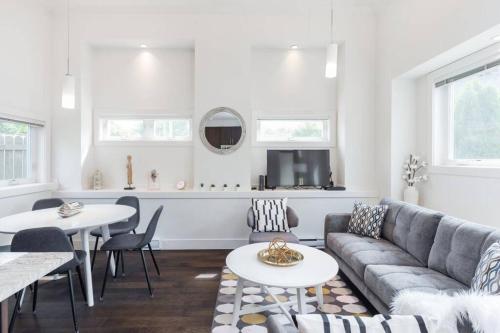 a living room with a couch and a table at West Coast Luxury Living in Vancouver