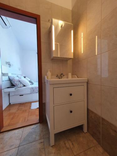 a bathroom with a sink and a mirror at Room Novakovic in Biograd na Moru