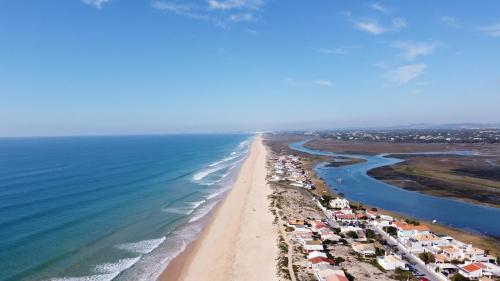 an aerial view of a beach with houses and the ocean at Ria Beach House in Faro
