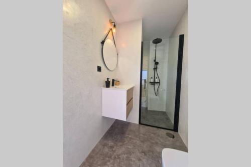 a bathroom with a mirror and a sink at Baobab House in Los Llanos de Aridane