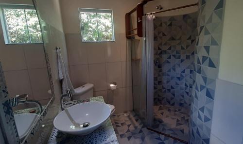 a bathroom with a sink and a shower at Recanto Flor Da Vida - Vale do Capao in Vale do Capao