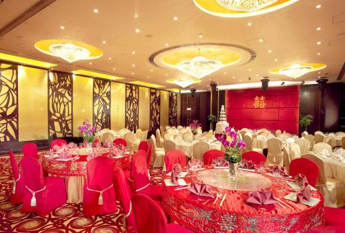 a banquet hall with white tables and red chairs at South Pacific Hotel in Hong Kong