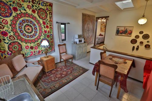 a living room with a table and a dining room at Sherezade by Majikal B&B in Cholula