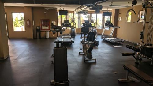 a gym with lots of exercise equipment in a room at Bella Sirena 305-A - Elegant Oceanview Condo on Beachfront Resort in Puerto Peñasco