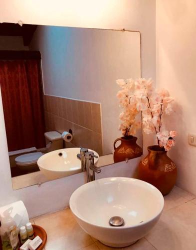 a bathroom with a white sink and a mirror at Luna Maya Antigua in Antigua Guatemala