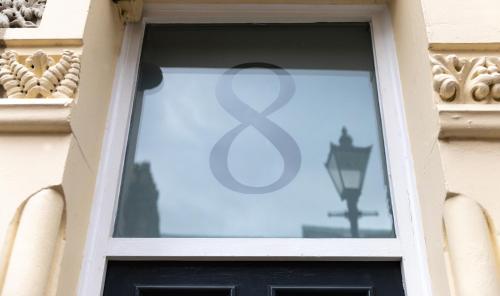a window with a peace sign on it at City Haven Preston Apartments in Preston