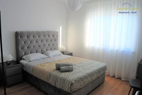 a bedroom with a large bed with a large headboard at Casa do Corval in Aldeia do Mato
