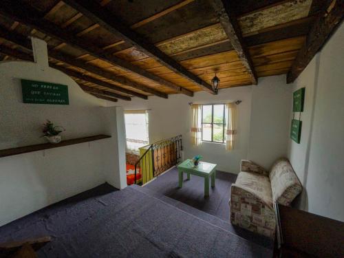 a living room with a couch and a table at Hotel Hacienda San Bartolo in Xico