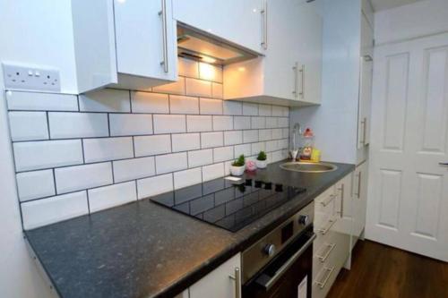 a kitchen with a counter top and a sink at Small Cosy Studio In Plaistow. East London in London