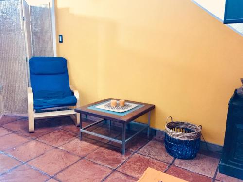 a blue chair and a table in a room at Casa Gavilán in Buenos Aires