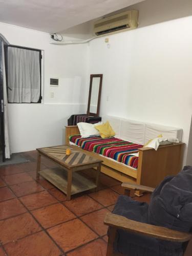 a living room with a bed and a coffee table at Casa Gavilán in Buenos Aires