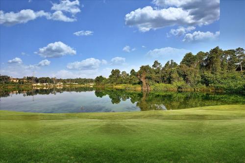 a view of a golf course with a lake at Lakeview Terrace Resort Pengerang in Pengerang