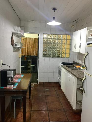 a small kitchen with a table and a counter top at Casa Gavilán in Buenos Aires