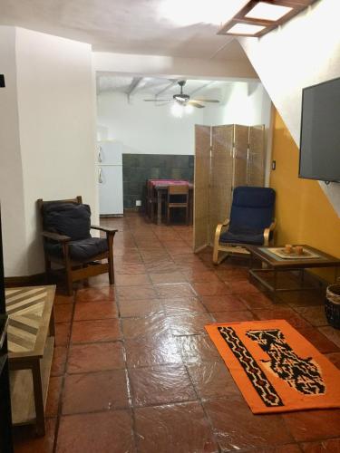 a living room with two chairs and a table at Casa Gavilán in Buenos Aires