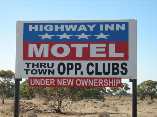 a sign for a motel in the middle of the desert at Highway Inn Motel in Hay