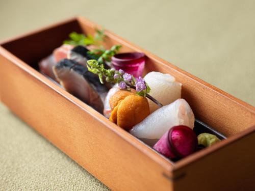 a wooden box filled with fruits and vegetables at Lake Shikotsu Tsuruga Bessou AO no ZA in Chitose