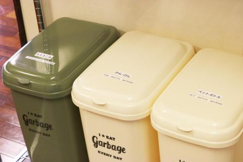 three ice cream buckets sitting in a refrigerator at Okinawa Naha JinJin -沖縄伝統体験型宿じんじん- in Naha