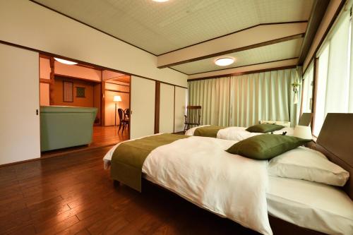 Postel nebo postele na pokoji v ubytování 山葵-WASABI