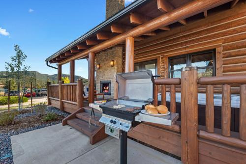 a grill on the porch of a house at Chic Retreat – Indoor/Outdoor Fireplace, Private Jacuzzi, Great Location! in Estes Park