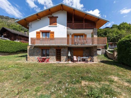 a house with a balcony and a large yard at Modern Holiday Home in Montagny with Balcony in Montagny