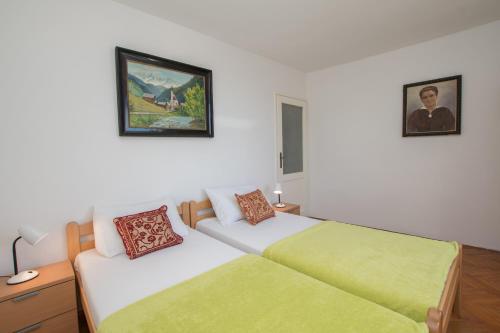 a bedroom with two beds and a painting on the wall at Historic Old Town apartment with the best view in town in Poreč