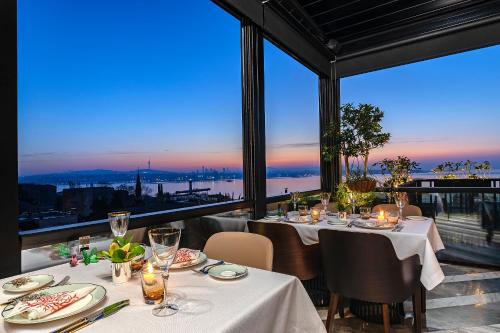 a dining room with tables and a view of the city at Aya Sultanahmet Hotel in Istanbul