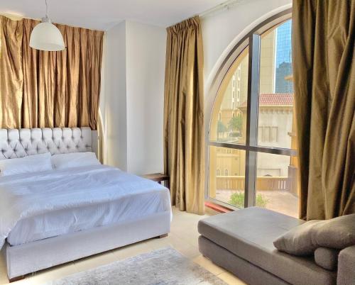 a bedroom with a bed and a large window at Amazing and spacious apartment in JBR in Dubai