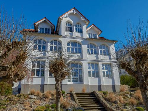 a large white building with stairs in front of it at Villa Li - Fewo 06 "Sonneninsel" in Ostseebad Sellin