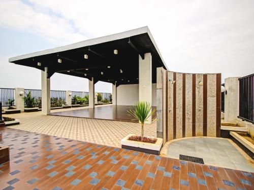 a pavilion with a black roof and a potted plant at Super OYO 90245 Tridasa in Medan