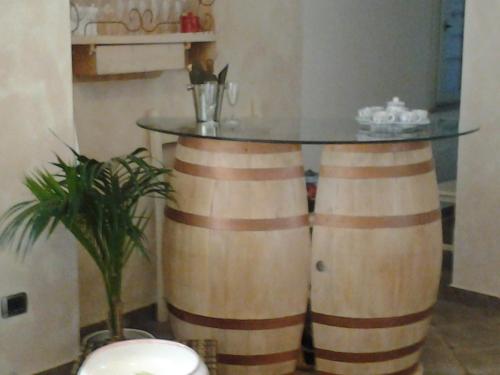 a table made out of wine barrels in a room at Hotel Sa Cralla Villasimius in Villasimius