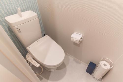 a bathroom with a white toilet in a stall at Alla Scuderia Bijou Suites in Osaka