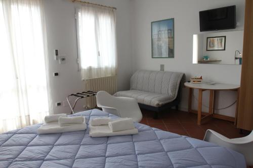 a bedroom with a large bed and a living room at AGRITURISMO CASA RICOTTA in Metaponto