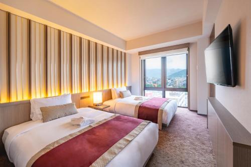 Ένα ή περισσότερα κρεβάτια σε δωμάτιο στο The Gate Hotel Kyoto Takasegawa by Hulic