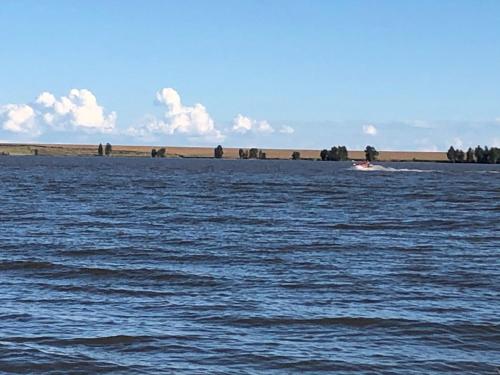 a large body of water with a boat in it at Best view family loft in Oranjeville