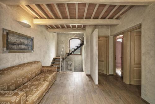 a living room with a couch and a staircase at Fattoria Casagrande in Rignano sullʼArno